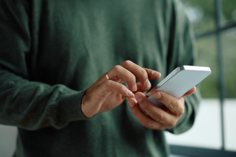 close up of man using mobile phone 2024 12 13 23 09 45 utc (1) (1)
